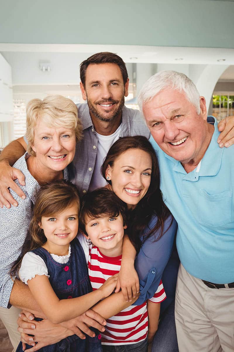 Portrait of cheerful family standing at home
